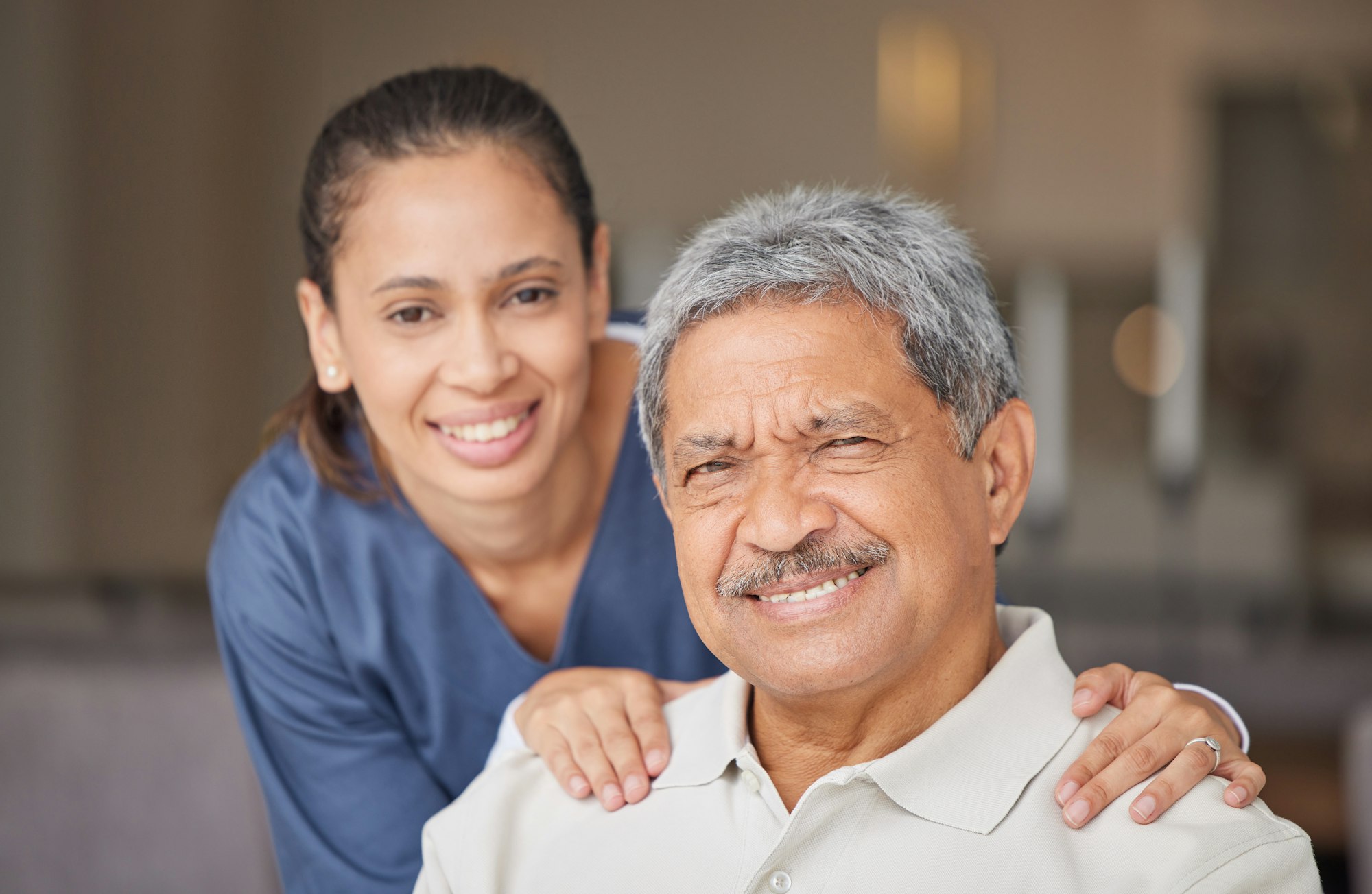 Portrait of elderly man with a nurse, bonding during a checkup at assisted living homecare . Smile,